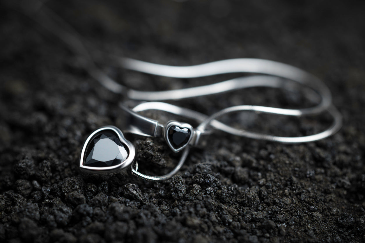 Beautiful jet ring and necklace on the volcanic rocks