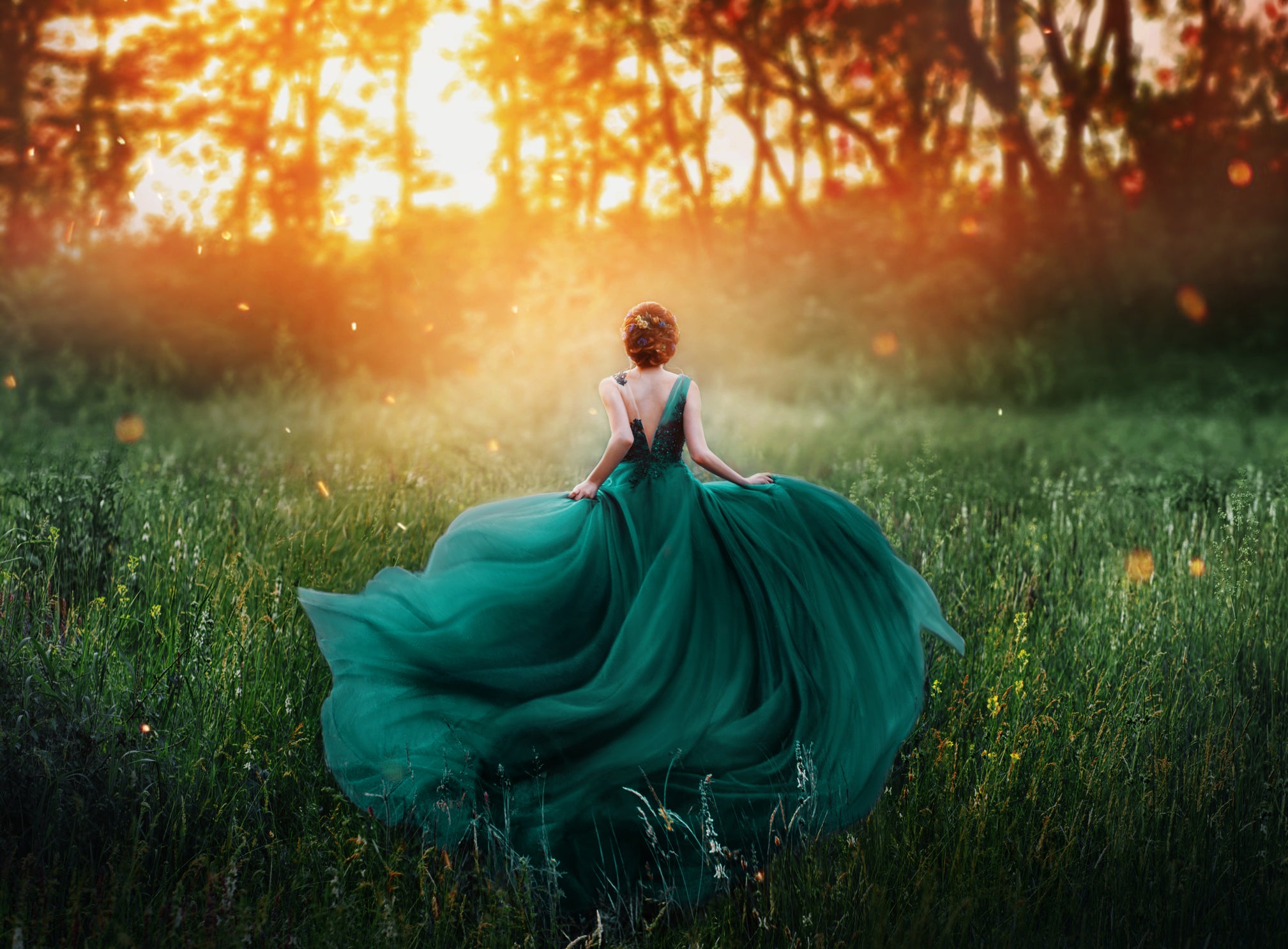 A woman in a flowing green dress stands in a field of tall grass, her movement reminiscent of an Art Nouveau painting