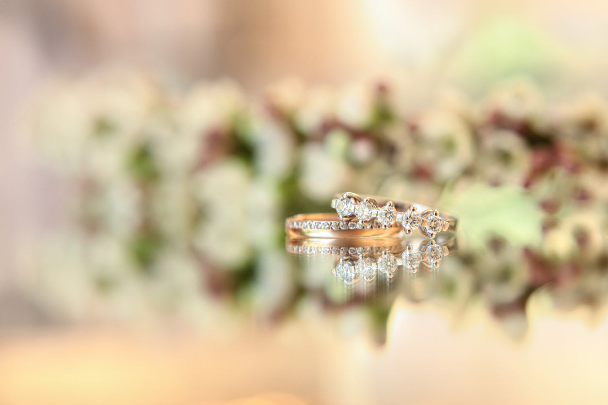 Gold wedding ring on flower background